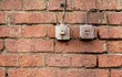 vintage industrial light switches on old weathered brick wall