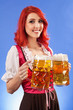 Beautiful woman serving beer at Oktoberfest