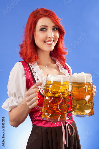Photo: Beautiful woman serving beer at Oktoberfest Beautiful woman serving beer at Oktoberfest