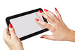 fingers with red nails touching a tablet-pc screen