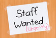 Sign on the Door Saying Staff Wanted Urgently