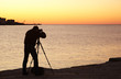 Photographer take a picture at sunset