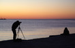 Photographer take a picture at sunset
