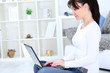 Cute young girl using a laptop at home
