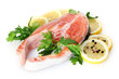 Red fish with lemon, parsley and pepper isolated on white.