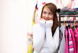 Young woman inside a store buying clothes