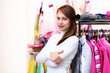 Young woman inside a store buying clothes