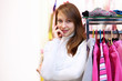 Young woman inside a store buying clothes