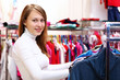 Young woman inside a store buying clothes