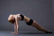young gymnast girl in black top lay on background young gymnast girl in black top lay on background