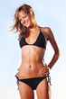 young smiling woman in bikini on sky background young smiling woman in bikini on sky background