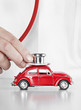 Close up of a doctor checking a play car with stethoscope
