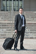 Young business man with suitcase.
