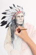 man hand drawing pencil picture with american indian chieftain