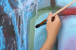 man hand painting blue abstract picture