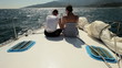 Young couple is on bow of the yacht