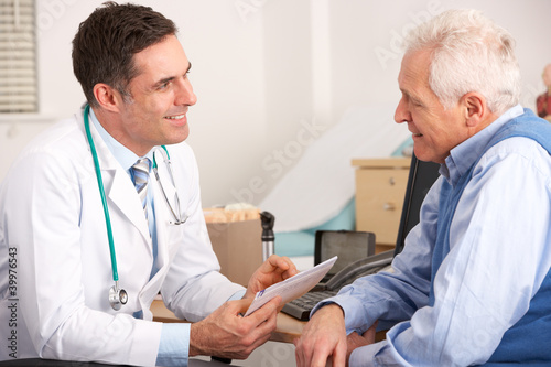 Photo: American doctor talking to senior man in surgery American doctor talking to senior man in surgery