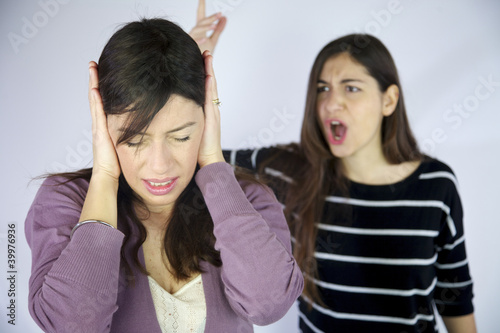 Photo: Girl closing her ears to not listen to shouts Girl closing her ears to not listen to shouts