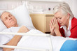 Senior woman with seriously ill husband in hospital