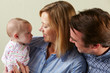 Studio Shot Of Happy Family With Baby