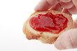 Foto: cut baguettes, strawberry jam in human hand on white background cut baguettes, strawberry jam in human hand on white background