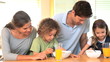 Video: Family in the kitchen with bowls of cereal Family in the kitchen with bowls of cereal