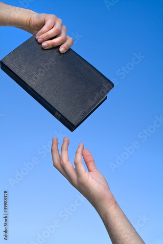 Photo: Hand Giving the Bible Hand Giving the Bible