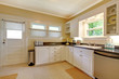 KItchen with white cabinets and stain steel appliances.
