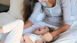 Mother tickling her daughter 