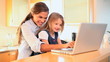 Mother and daughter watching a video on a laptop