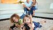 Children playing video games to the on a carpet