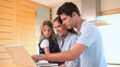 Family looking a laptop screen