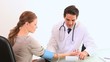 Video: General practitioner taking the blood pressure of his patient General practitioner taking the blood pressure of his patient