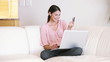 Video: Lady sitting on the couch while using her credit card Lady sitting on the couch while using her credit card
