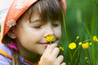 Girl Smelling A Flower