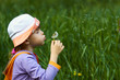 girl blowing a dandelion