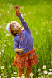 girl playing with a dandelion