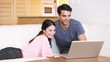 Video: Smiling couple looking at a laptop Smiling couple looking at a laptop