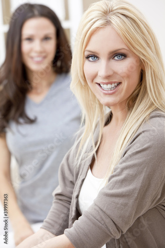 Photo: Two Young Women Friends At Home on Sofa Two Young Women Friends At Home on Sofa