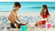Siblings building sand castles