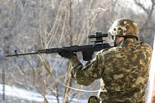 Photo: Portrait of soldier with a sniper rifle Portrait of soldier with a sniper rifle