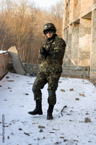 Photo: Strong military man with weapon Strong military man with weapon