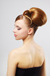 Beautiful girl with retro hairstyle on gray