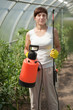 Female gardener with garden spray Female gardener with garden spray