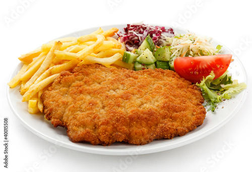 Photo: Pork chop, French fries and vegetables Pork chop, French fries and vegetables