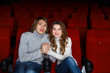 Young couple in cinema watching movie Young couple in cinema watching movie