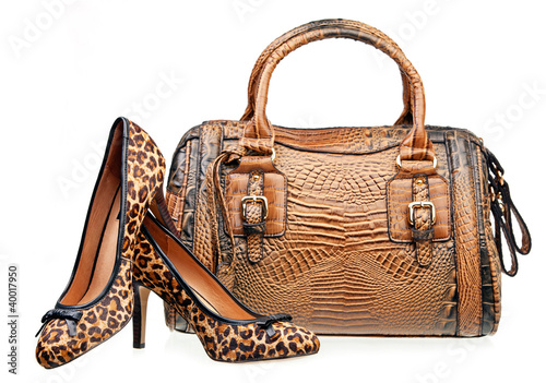 Photo: Pair of women shoes and handbag isolated over white Pair of women shoes and handbag isolated over white