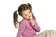 Close-up of adorable little girl with a lollipop