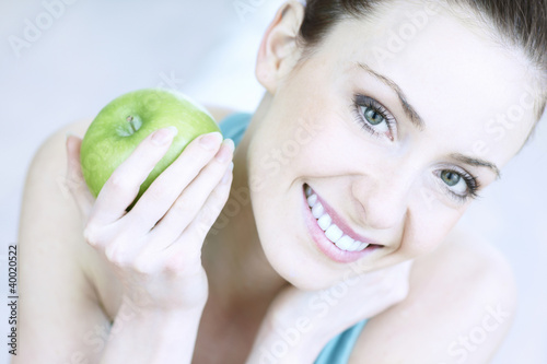 Photo: portrait of young woman with apple portrait of young woman with apple