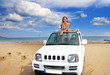 Greece. Rhodes.The young beautiful woman in the car on seacoast Greece. Rhodes.The young beautiful woman in the car on seacoast